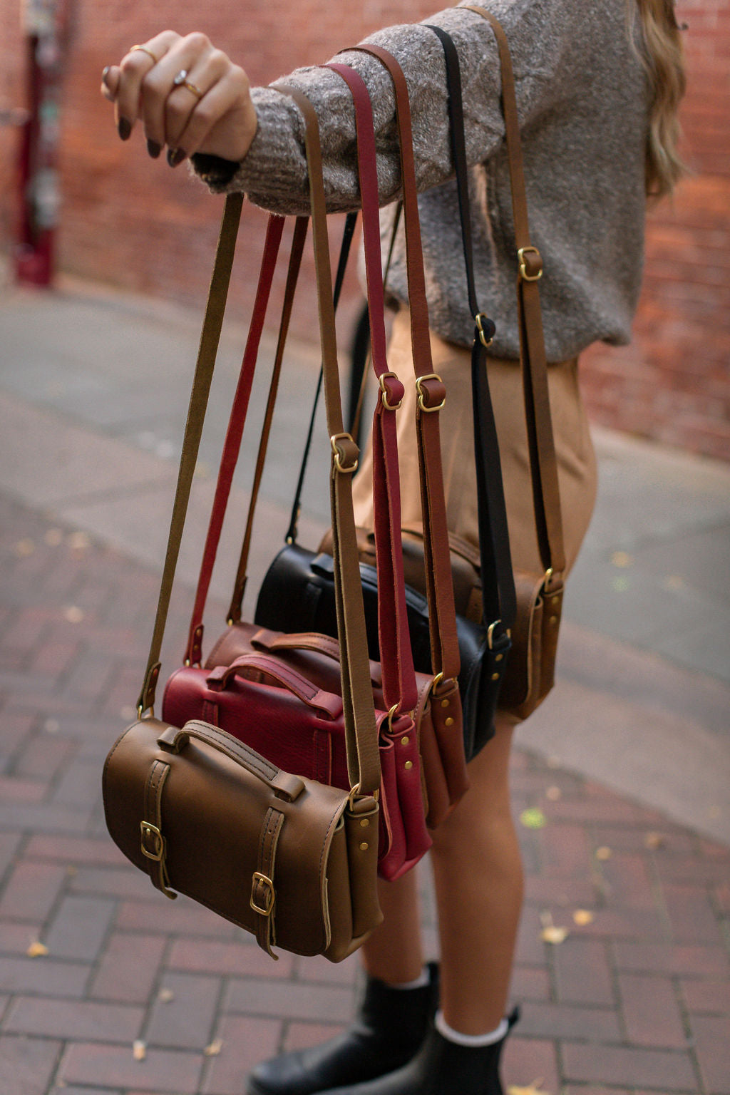 Handmade Leather Carriage Crossbody shown in all five colors: Mocha, Merlot, Cognac, Black, and Rustic Brown.