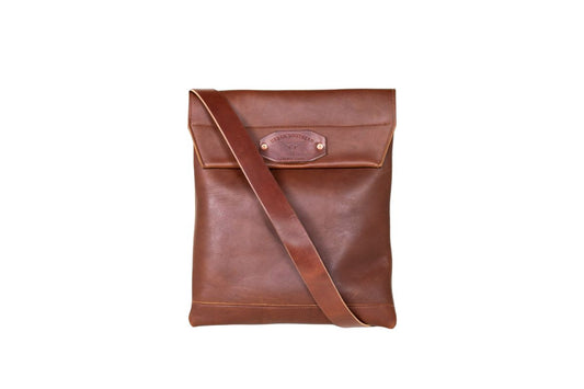brown leather courier bag, featuring an adjustable strap and magnetic closure.