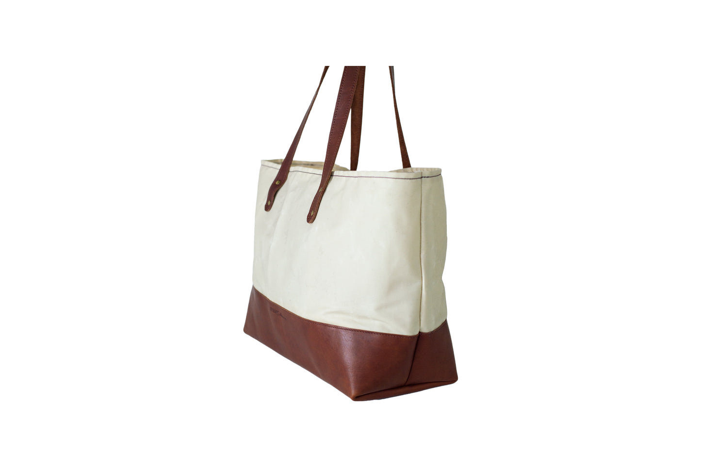 Side view of the Urban Southern handcrafted leather Large Canvas Tote.