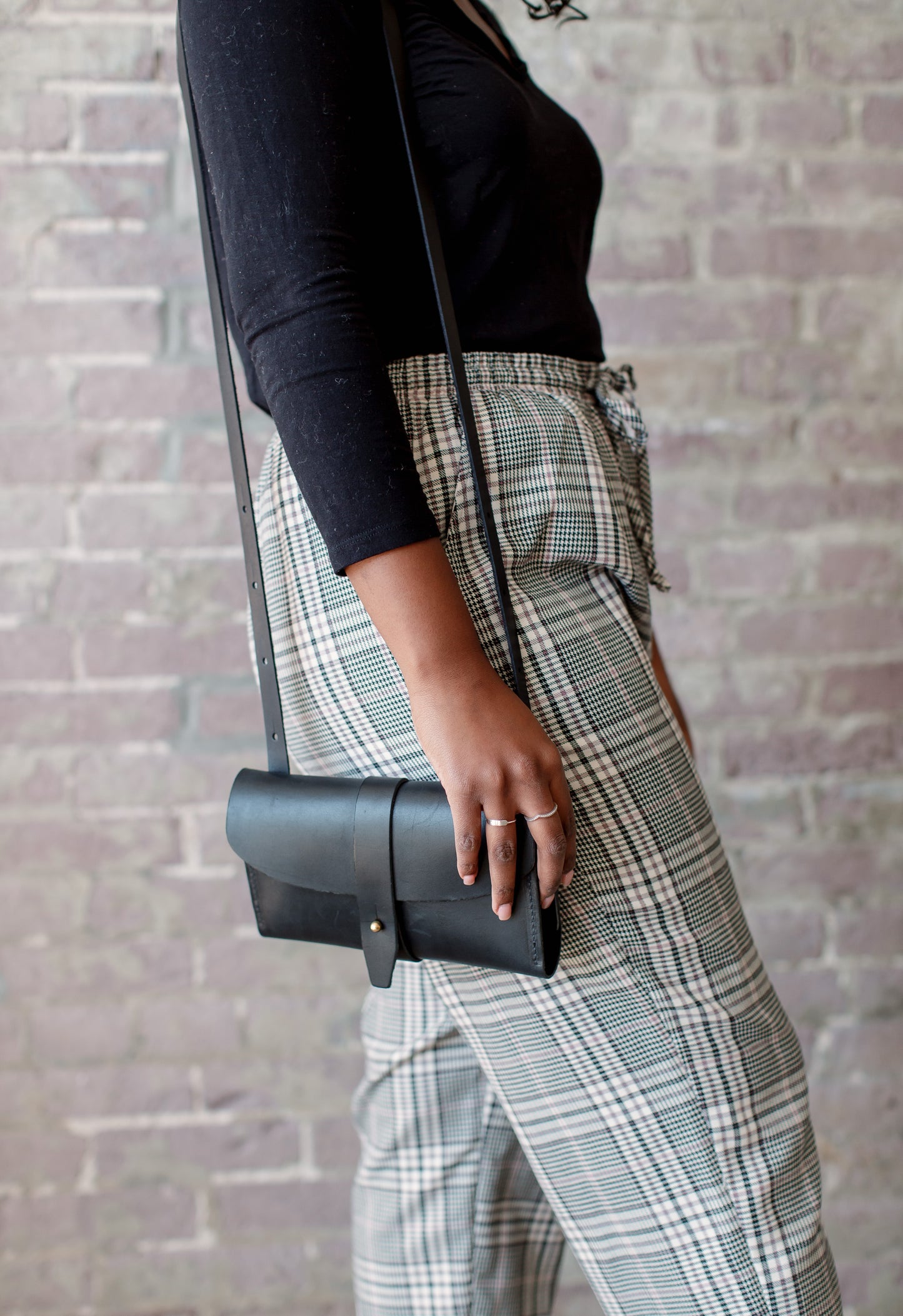 The adjustable strap at maximum length on the Crossbody Wallet lands at mid-thigh, making it easy to reach and access.