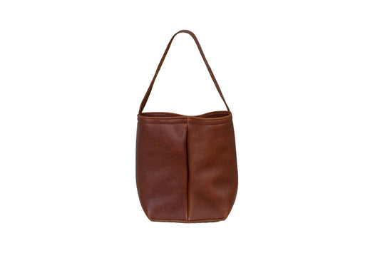 The Urban Dual Wine Tote, handcrafted from full-grain leather, featuring a carry handle & two interior compartments large enough to hold two standard sized wine bottles.