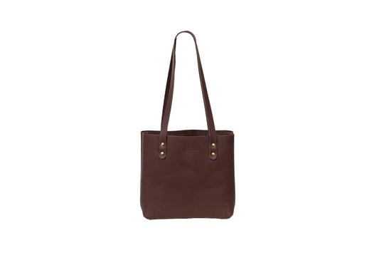 The handcrafted Mini Urban Tote, featuring beautiful full-grain leather & brass rivets.