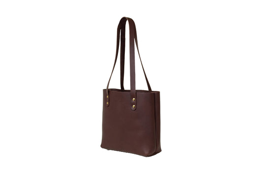 The handcrafted Mini Urban Tote, featuring beautiful full-grain leather & brass rivets.