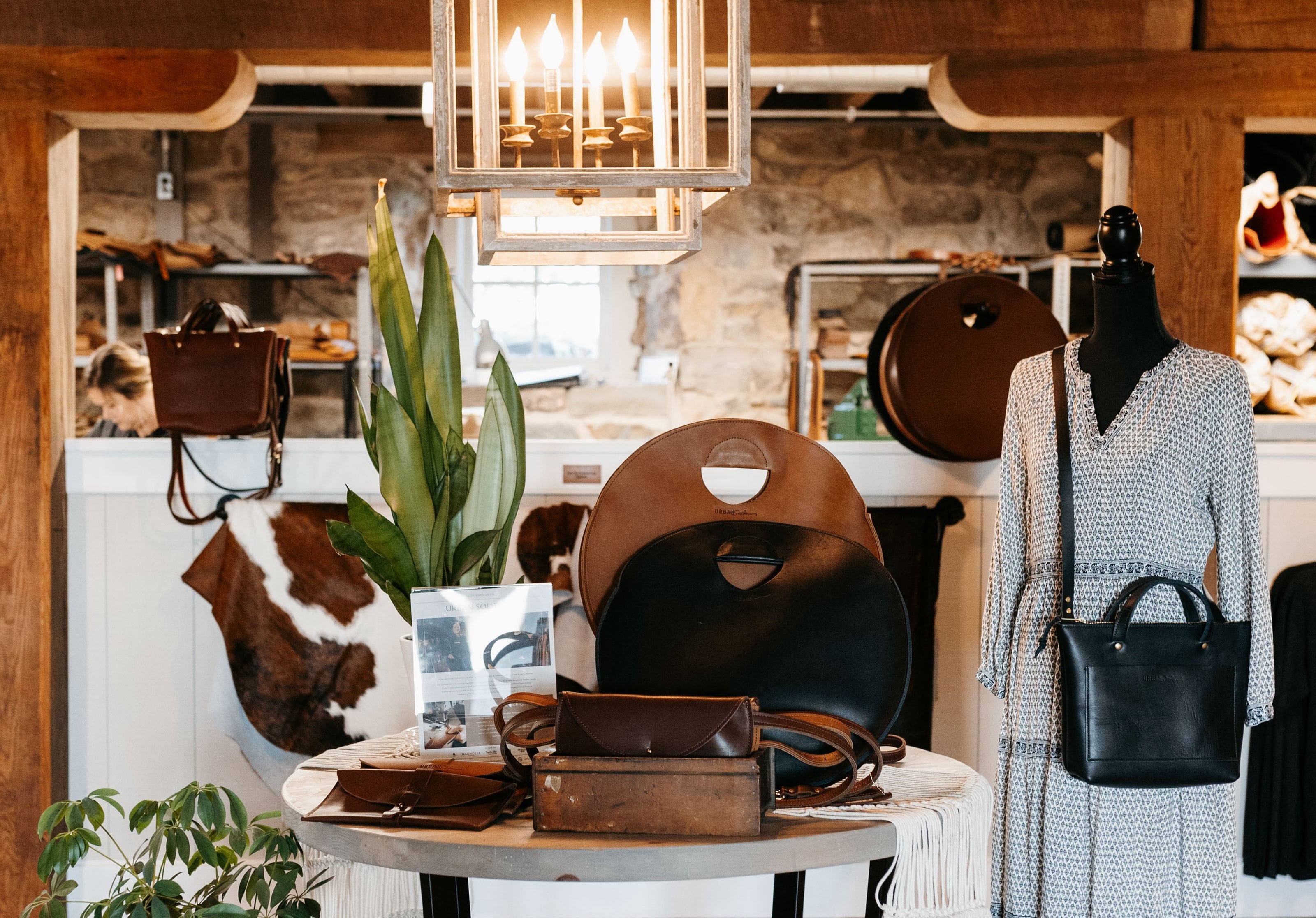 The Urban Southern store entry table, featuring a selection of leather handbags.