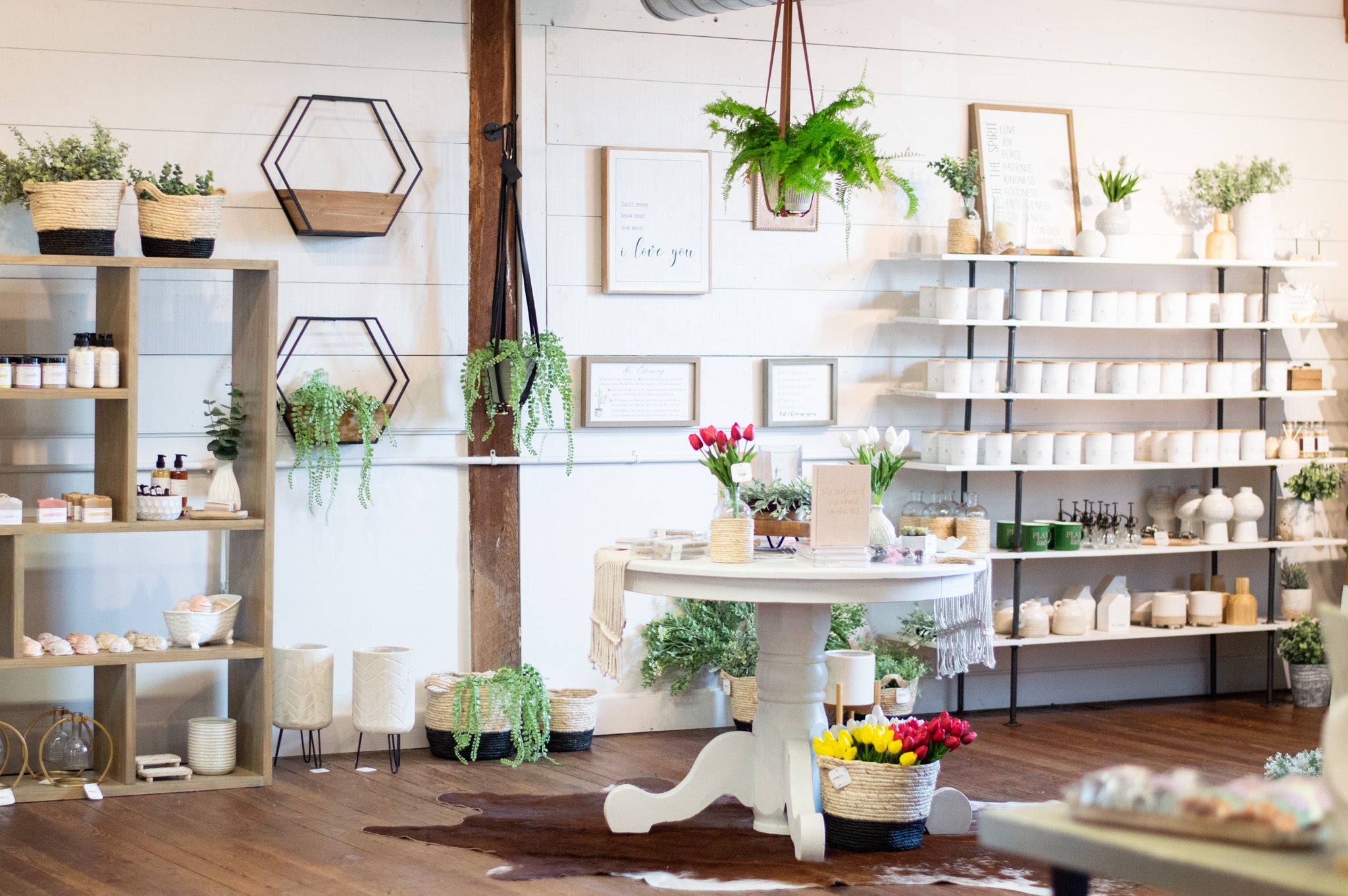 A table display of home decor & candles at the Urban Southern store.