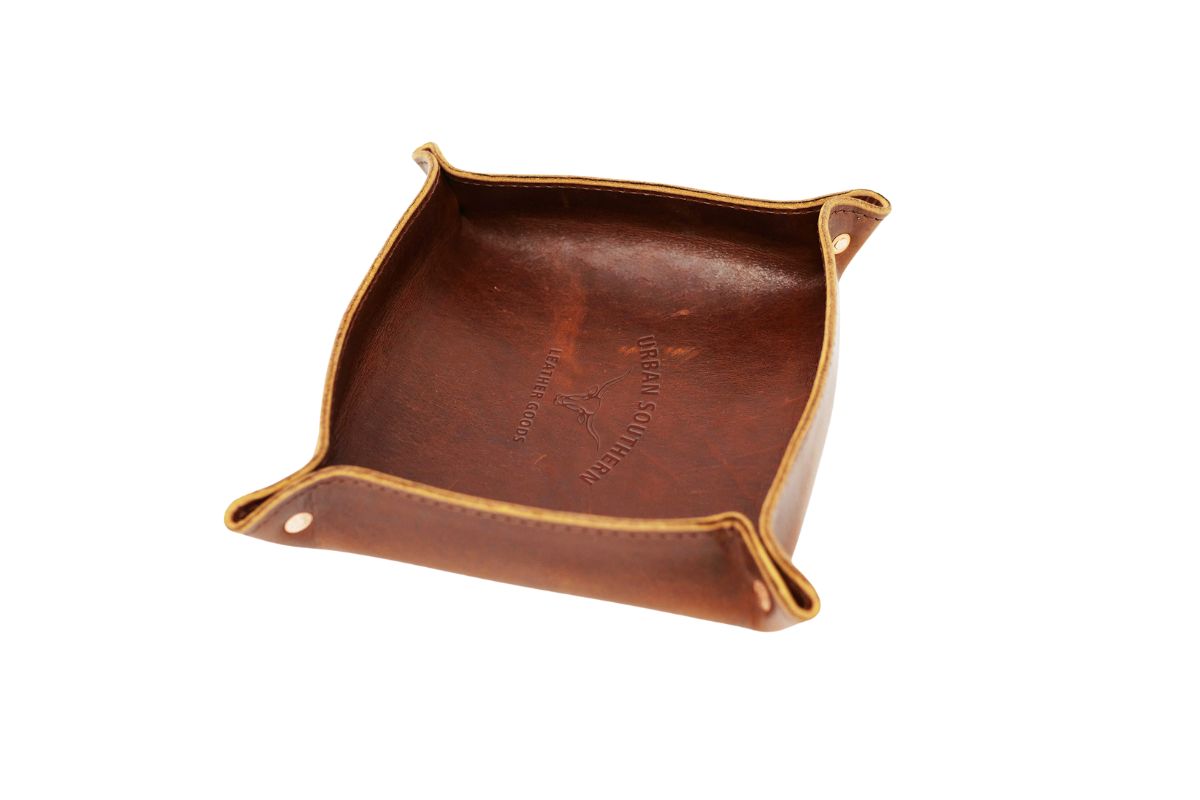 A close up view of the valet tray, featuring rich, full-grain leather and copper rivets.