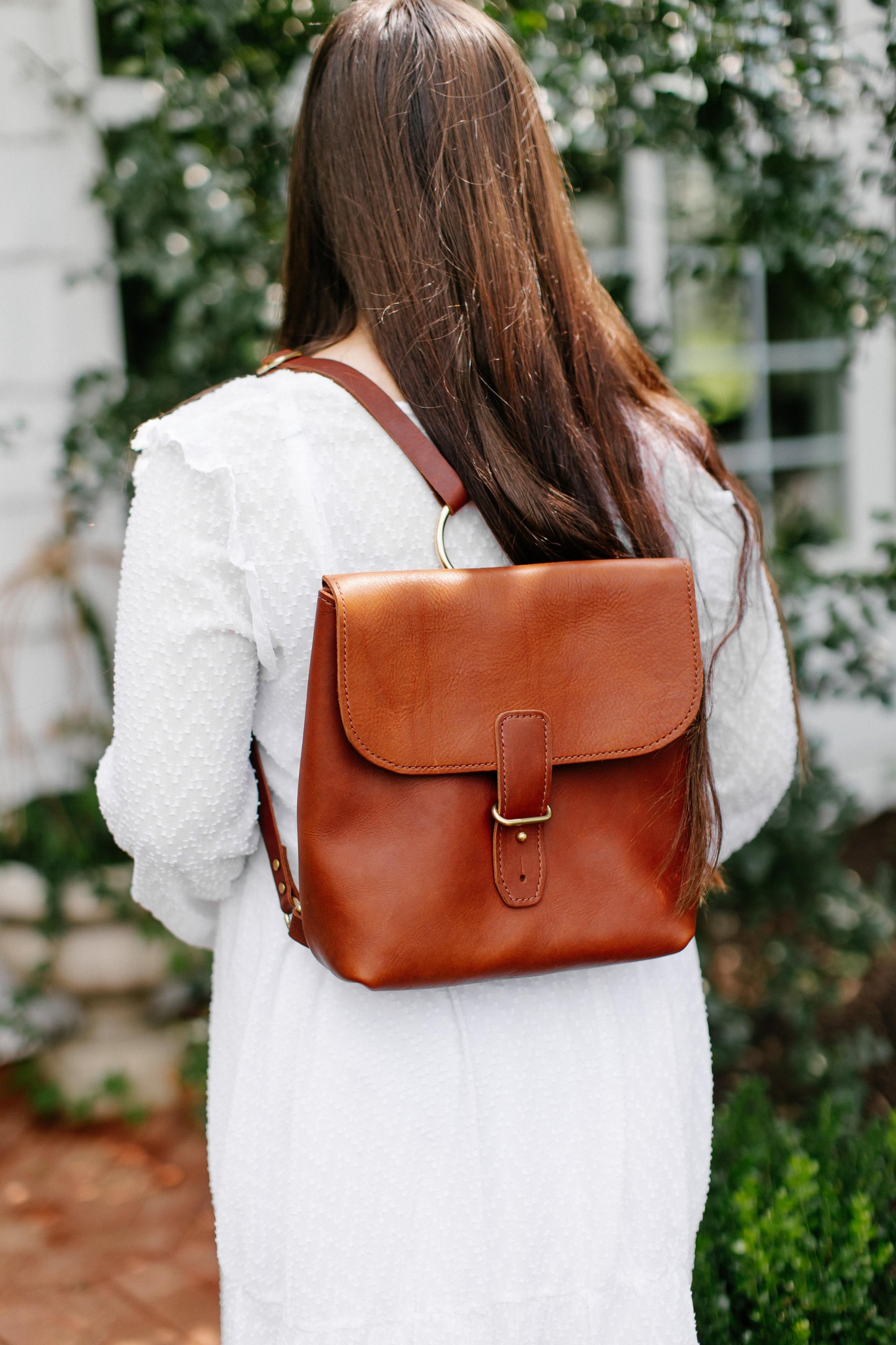 A woman carries the Monterey Backpack on her back.