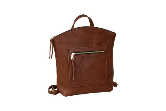 The Urban Southern handcrafted leather Brooklyn Backpack features brass hardware, zipper, and engraved Urban Southern logo. Shown in Cognac.