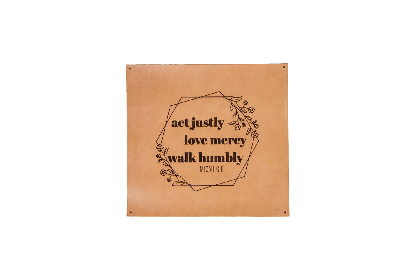 The Urban Southern handcrafted square leather sign features the engraved words, "Act justly, Love mercy, Walk humbly. Micah 6:8" surrounded by engraved flowers and overlapping hexagon outlines.