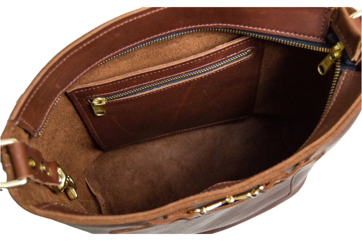 A view of the interior of the Lexington Julep handbag, featuring one slip pocket, one zipper pocket & a key fob.