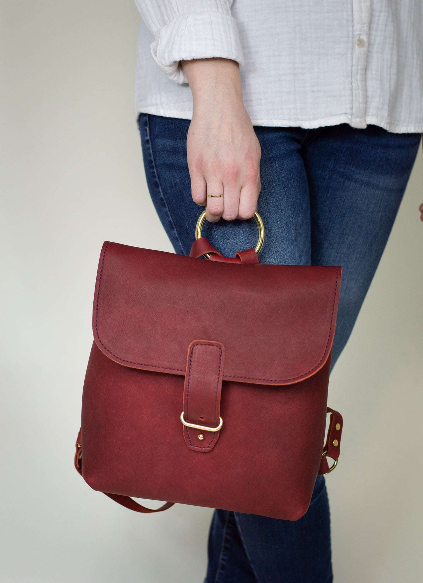 The brass ring on the Monterey Backpack also doubles as a carrying handle if you don't wish to carry it on your back or shoulder.