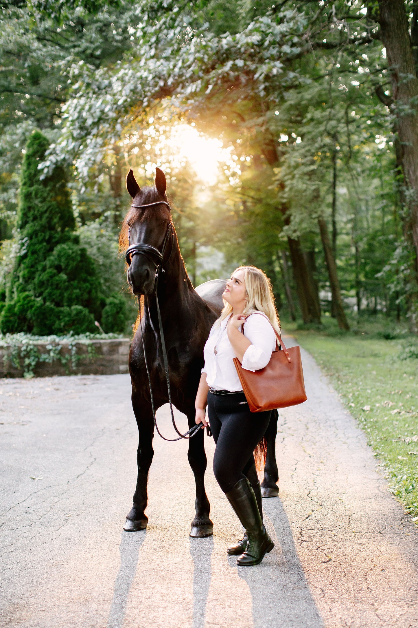 A woman holds the Classic Tote over her shoulder.