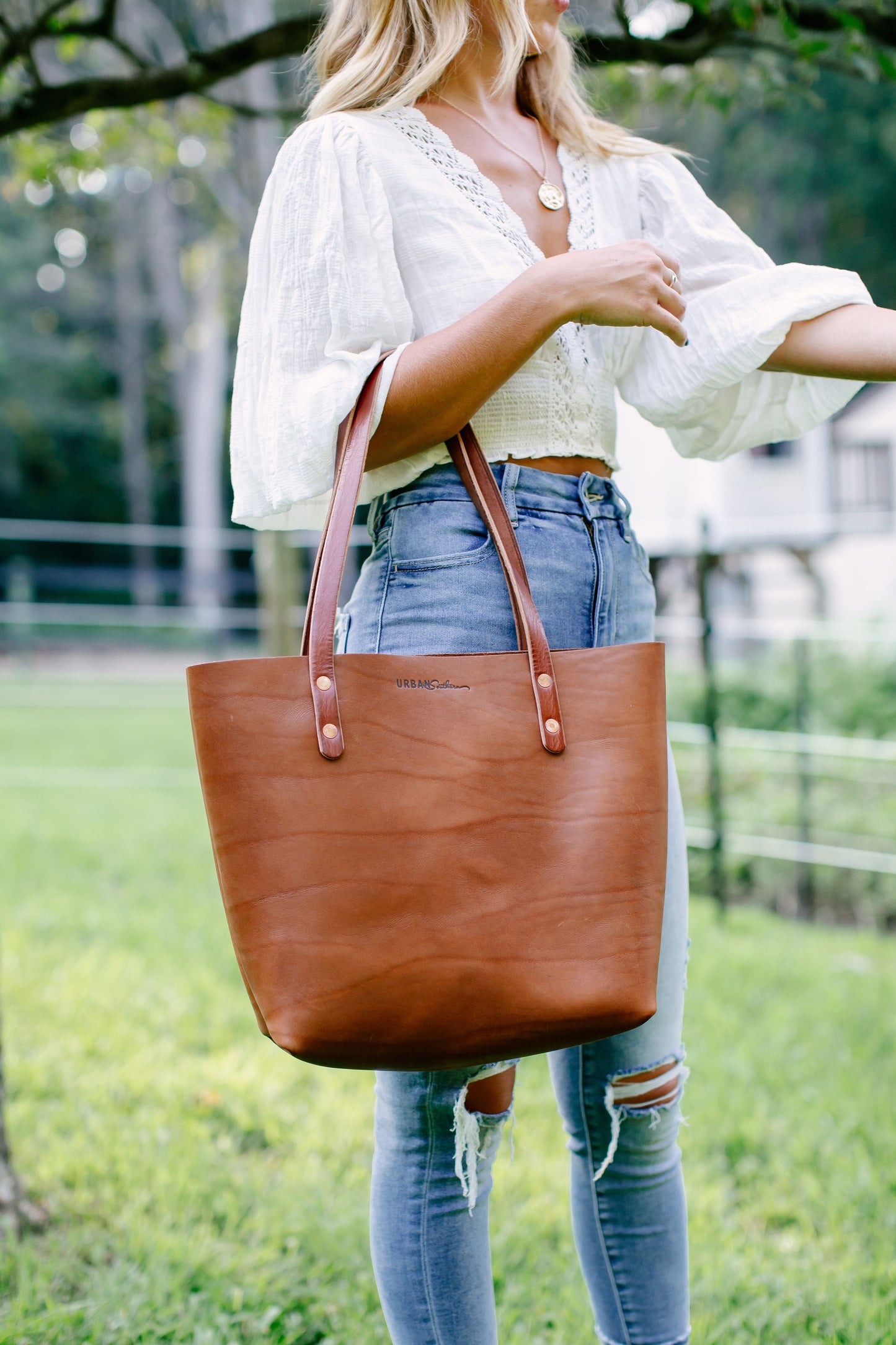 A woman carries the Classic Tote on her arm.