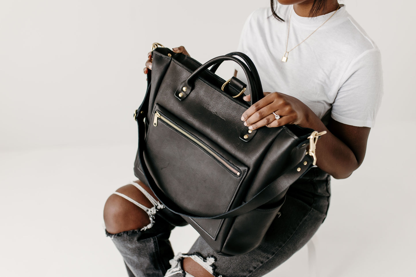 The Urban Southern Legacy Backpack Tote straps can easily switch into different carrying positions using the brass clips.