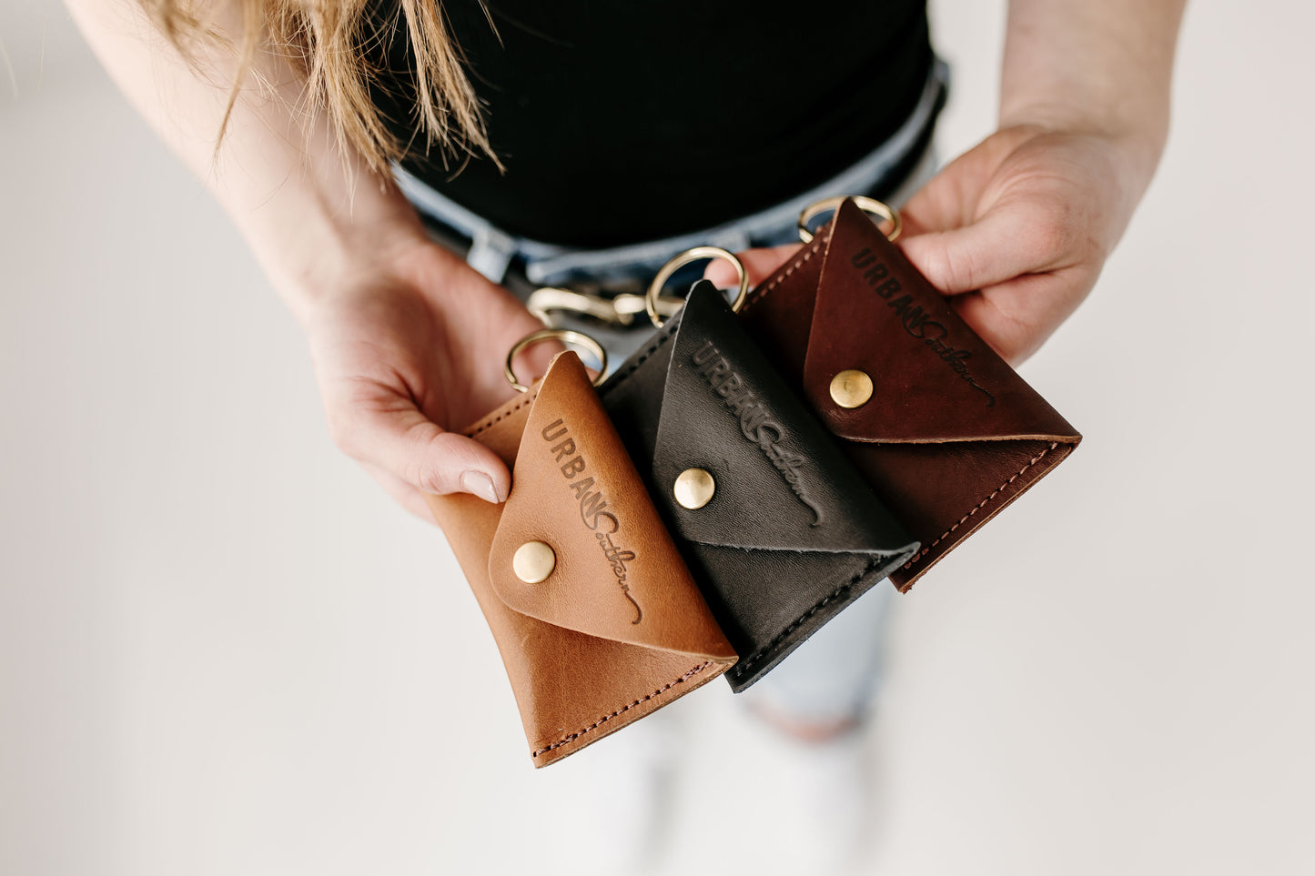 The Urban Southern Keychain Coin Purse is shown in three different colors: Honey, Black, and Chestnut Brown.