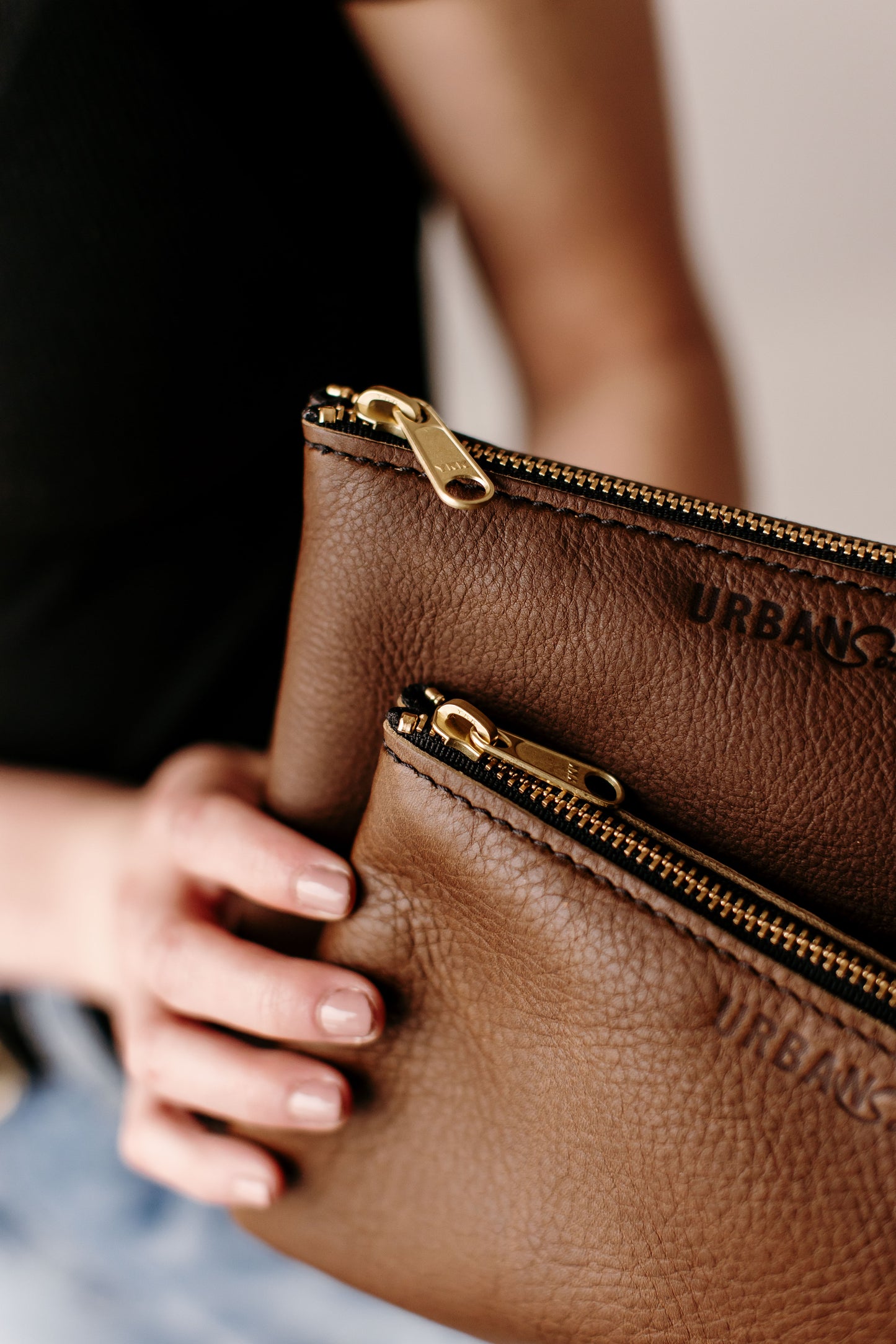 The handcrafted leather Zipper Pouches features a brass zipper and engraved Urban Southern logo.