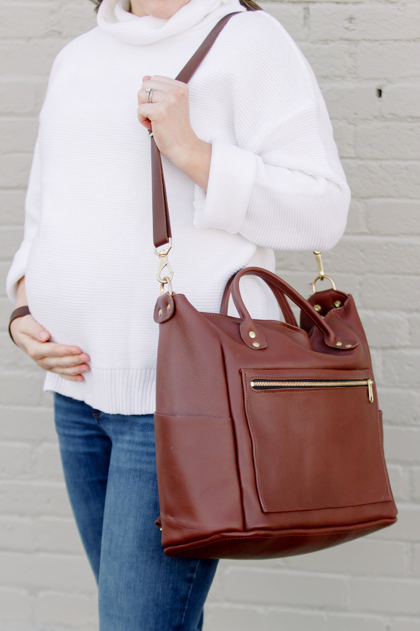 Carry the Legacy Backpack Tote over one shoulder like a traditional purse by attaching only one strap.