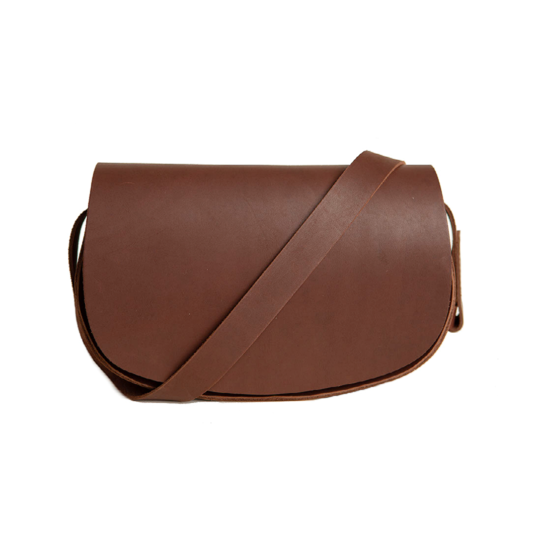 The Urban Southern handcrafted leather Half Moon Crossbody in Chestnut Brown, features an adjustable leather strap and engraved Urban Southern logo inside underneath the outer flap.
