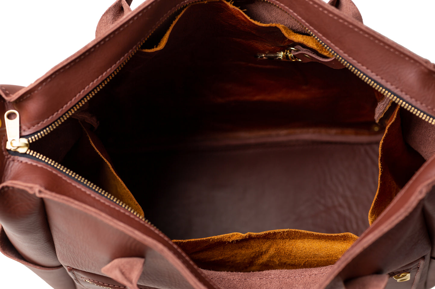 The large open inside storage area of the Legacy Backpack Tote with four additional interior pockets and a key ring snap.