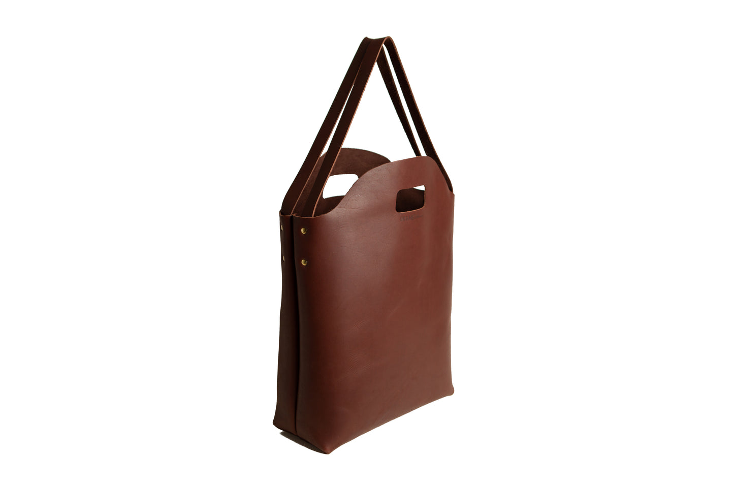 The Urban Southern handcrafted leather Market Tote in Chestnut Brown features brass accents and the Urban Southern logo engraved on the front.