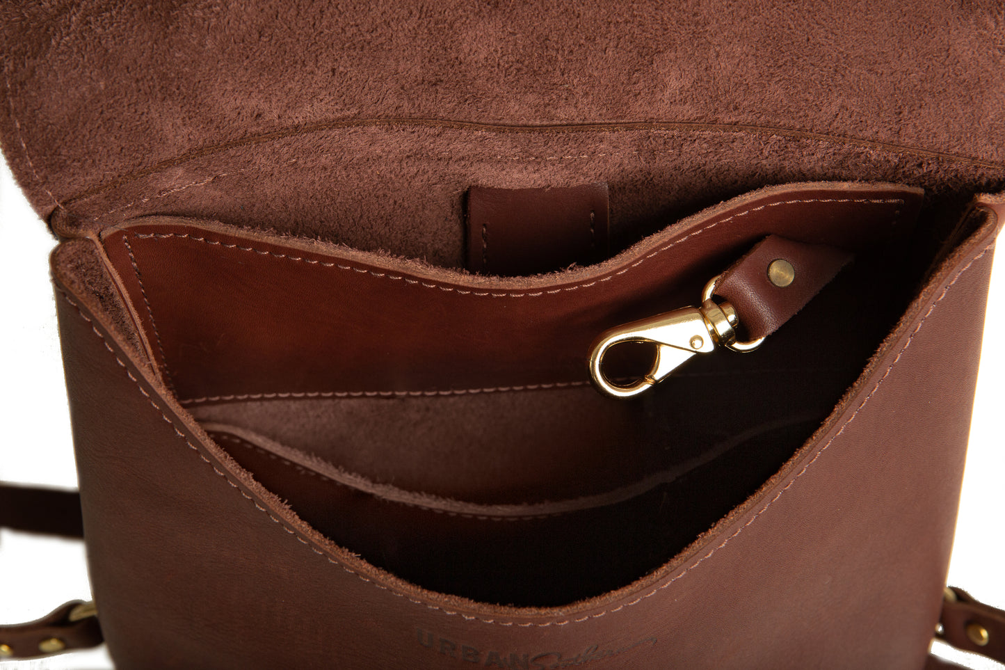 The inside storage area of the Monterey Backpack includes several pockets plus an attached brass key ring.