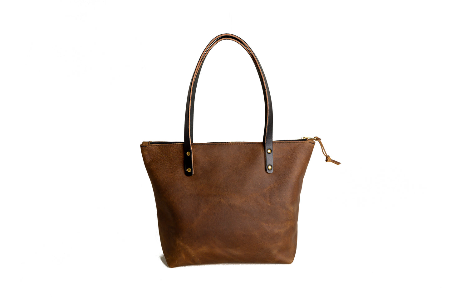 A view of the back of the Mocha Urban Zipper Tote, featuring two toned black bridle leather handles.