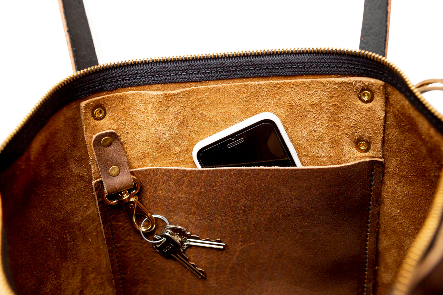 The Urban Zipper Tote's interior slip pocket is roomy enough to fit an iphone. While its interior key fob makes keeping track of your keys easier than ever.