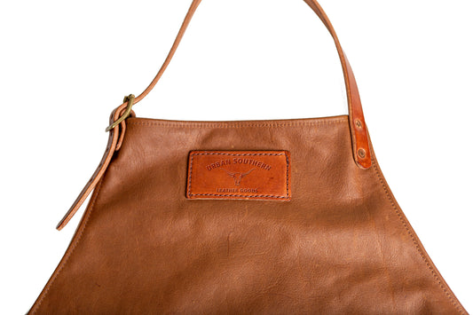 brown leather apron featuring a branded urban southern patch