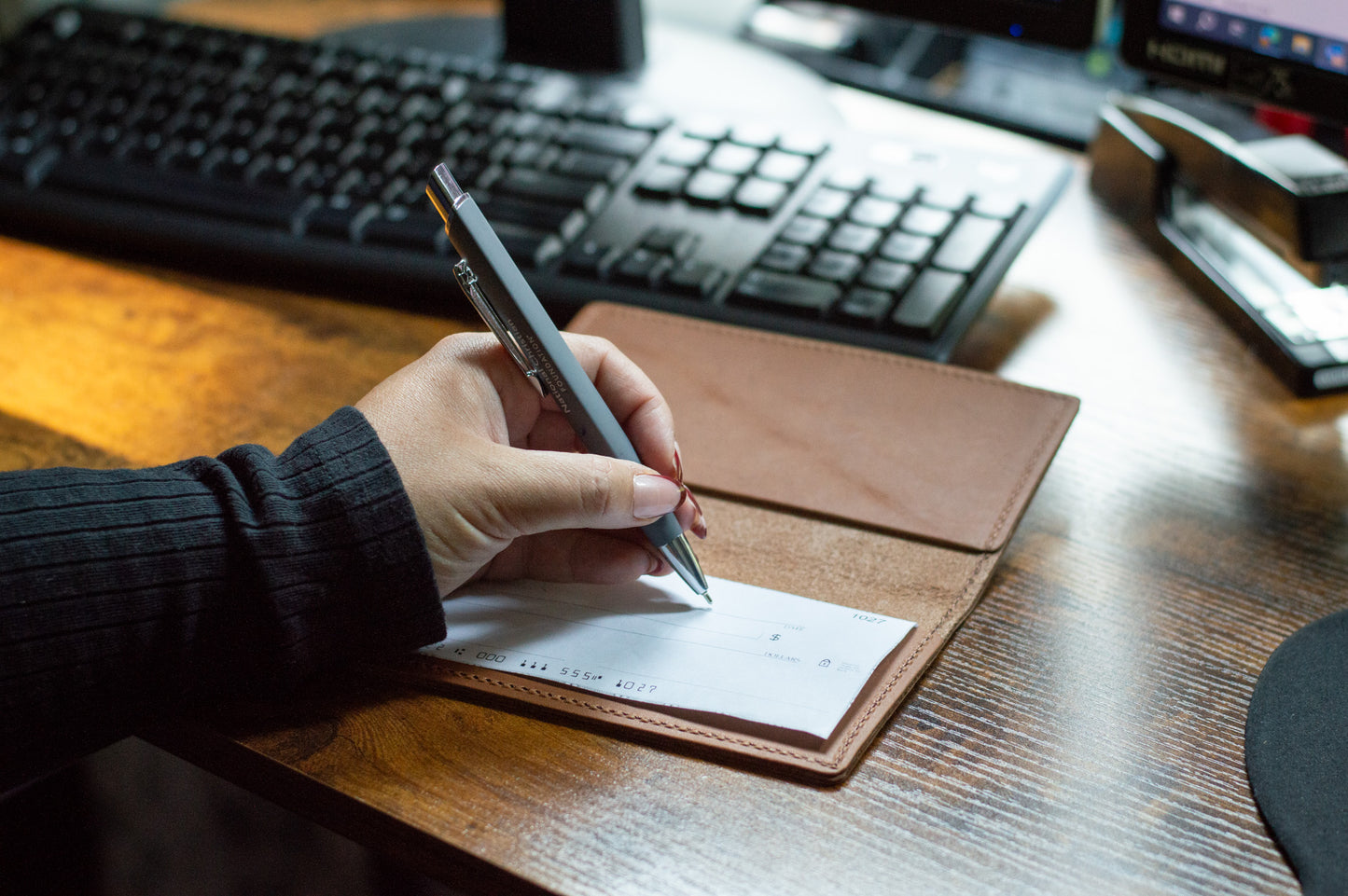 The back of the checkbook can be slipped into one of the leather pockets for easy access when opening the Checkbook Cover.