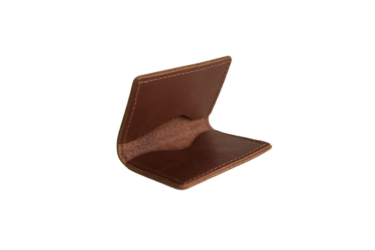 Brown leather bifold card wallet with two interior pockets