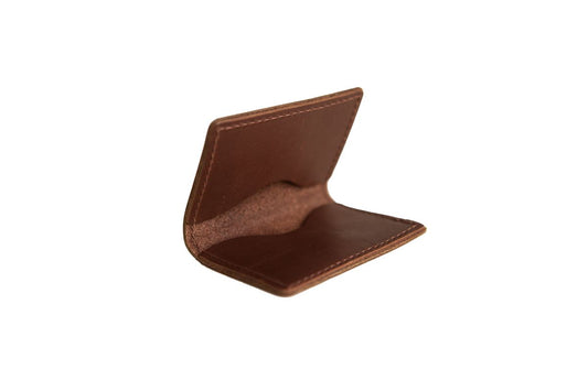 Brown leather bifold card wallet with two interior pockets