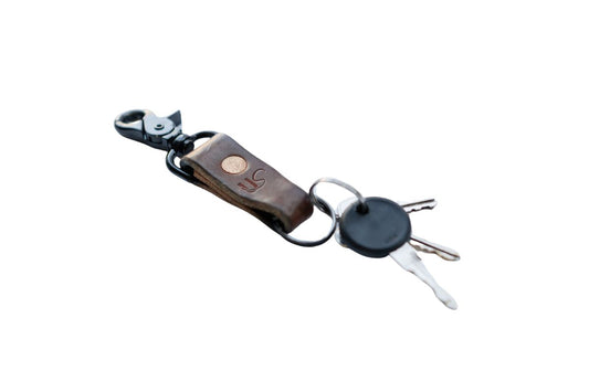 Leather keychain with black hardware on a white background