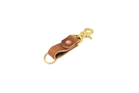 Brown leather key fob with brass hardware on a white background