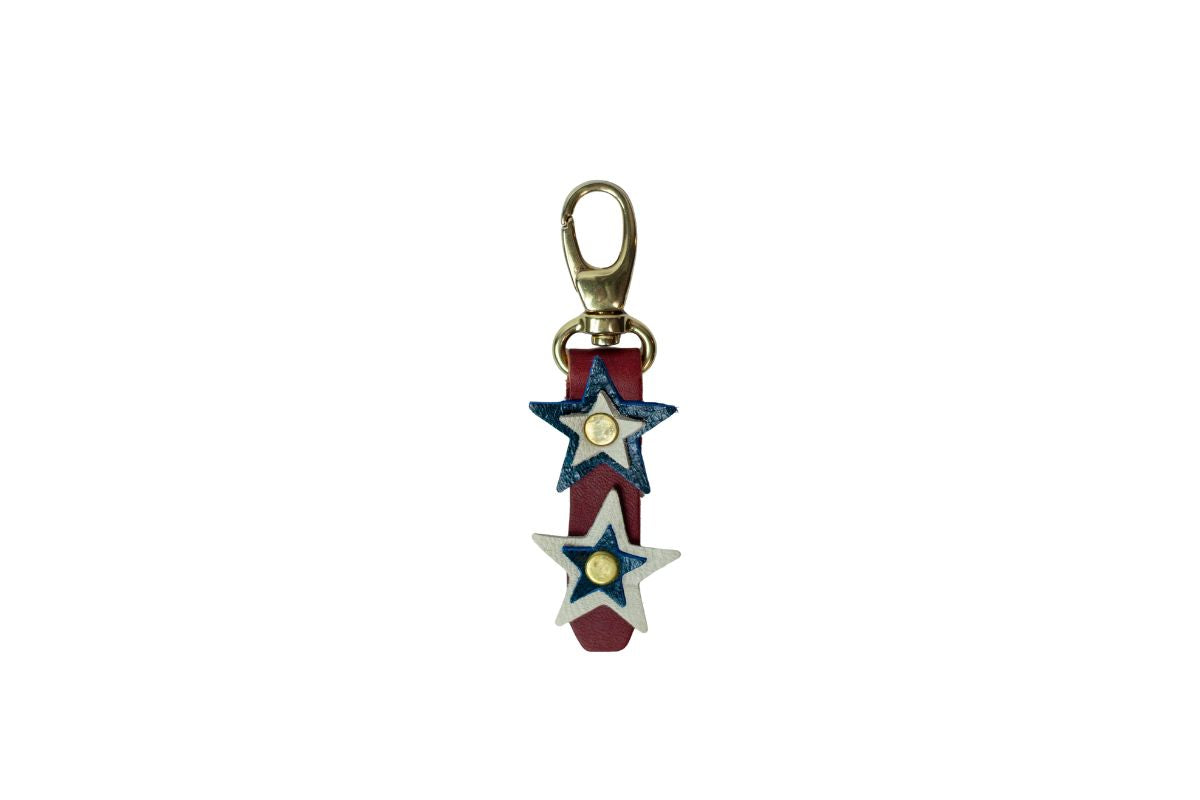 Star-shaped keychain with red, white, and blue colors on a white background, brass snap clip.