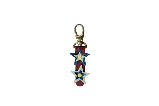 Star-shaped keychain with red, white, and blue colors on a white background, brass snap clip.