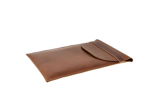 Brown leather protective laptop sleeve on a white background