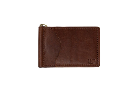 The front view of a brown leather money clip bifold wallet, with front card slot and brass money clip. 