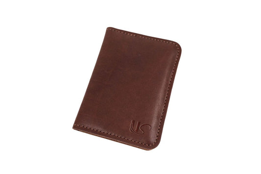 The exterior of a brown leather passport wallet with a US logo on a white background