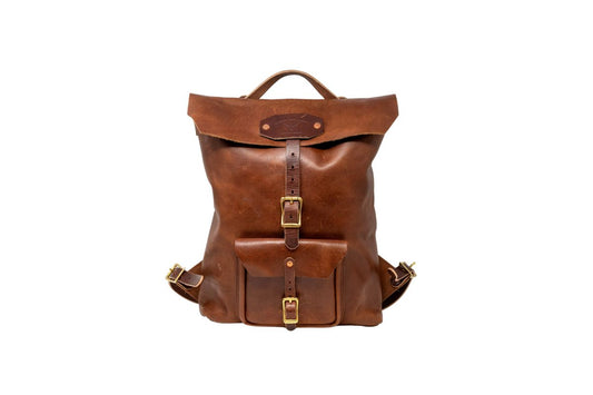 Brown leather backpack with sturdy brass hardware on a white background
