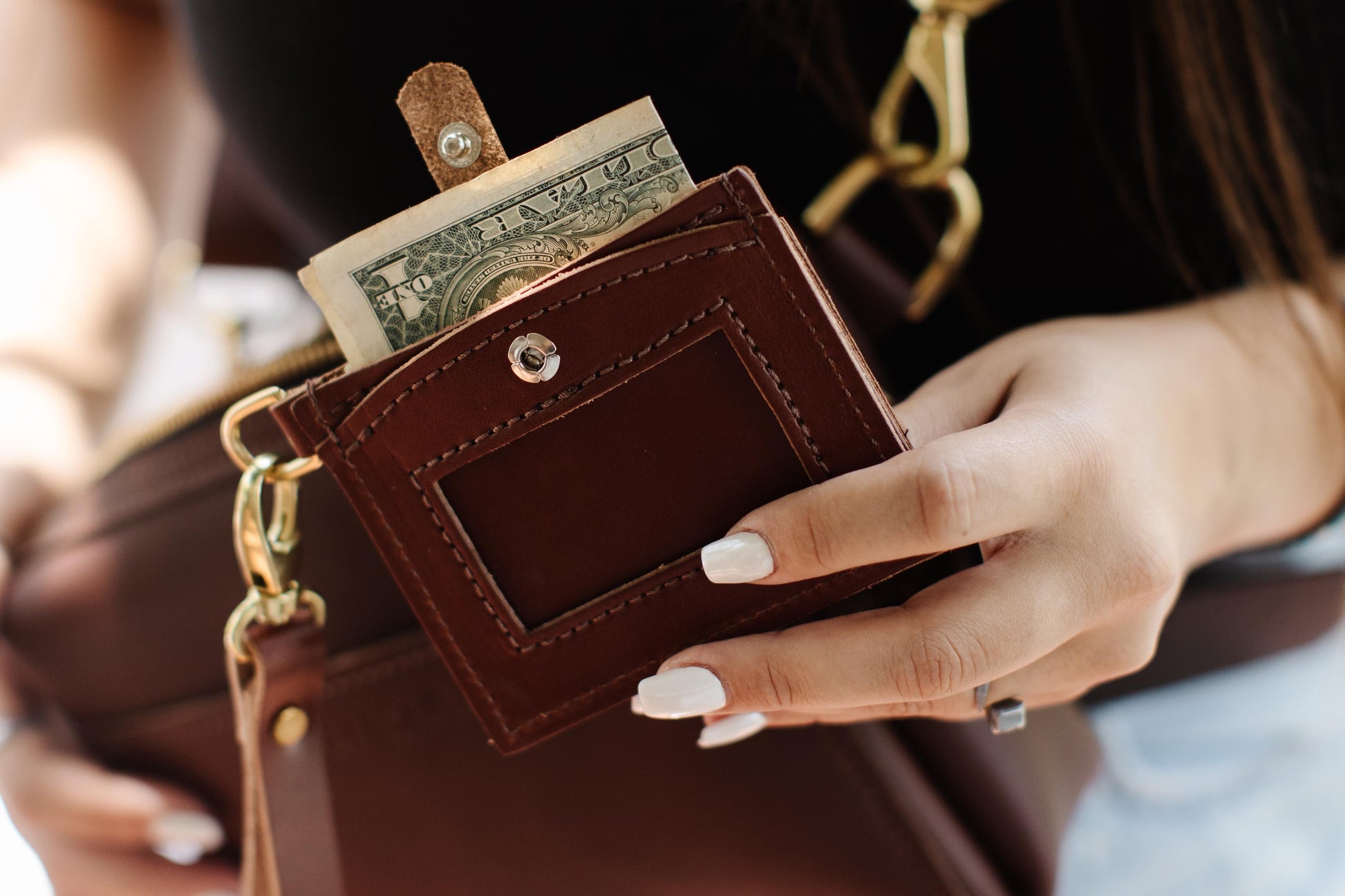 Dollar bills folded in half easily fit into the cash pocket on the Everly Wristlet Wallet.