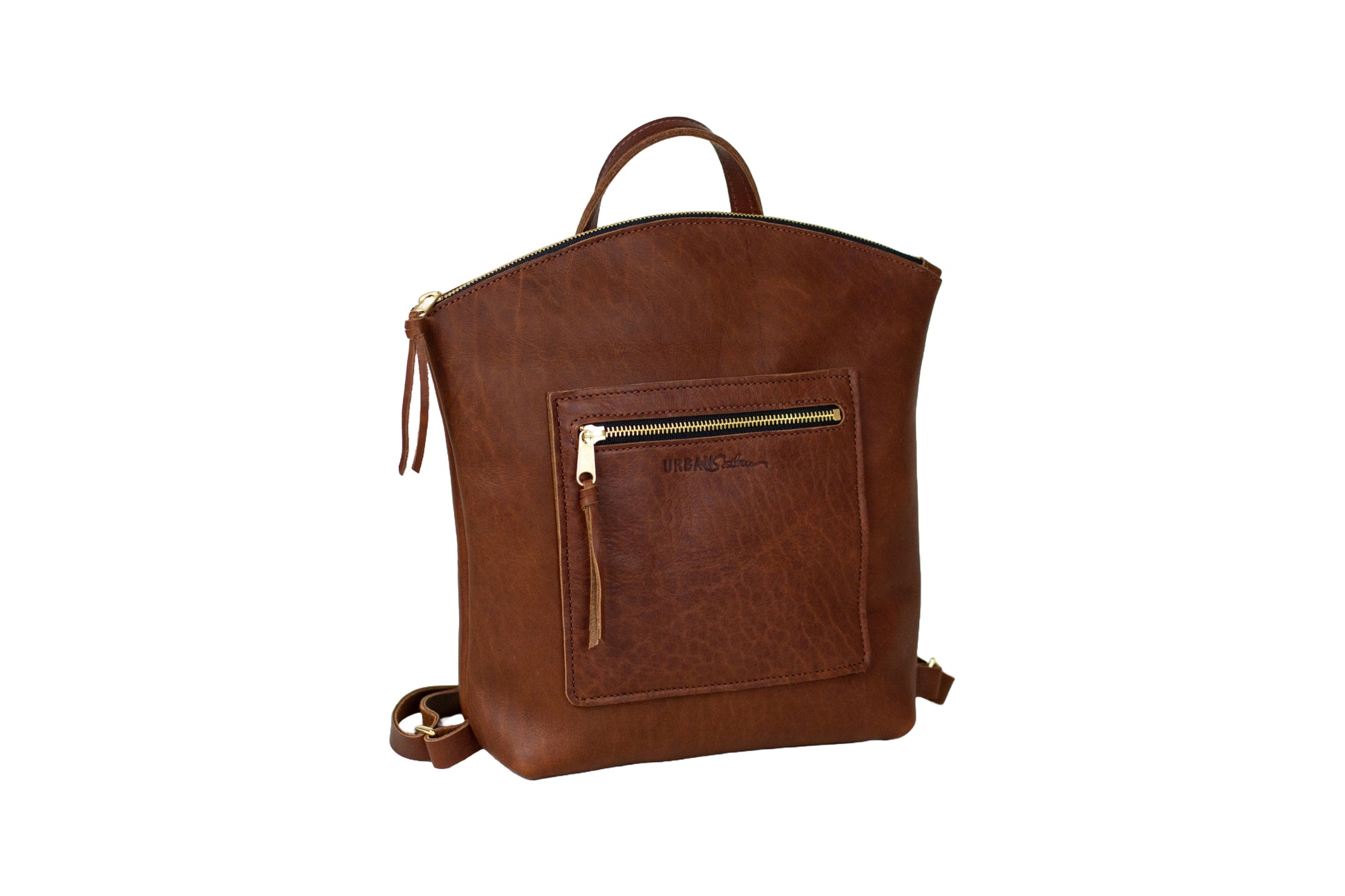 The Urban Southern handcrafted leather Brooklyn Backpack features brass hardware, zipper, and engraved Urban Southern logo. Shown in Cognac.