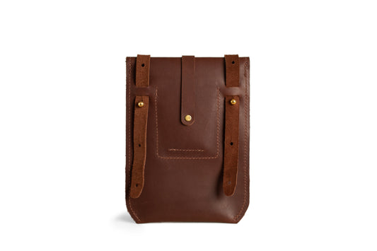 A view of the back of a chestnut Postal Crossbody & its adjustable leather strap. 