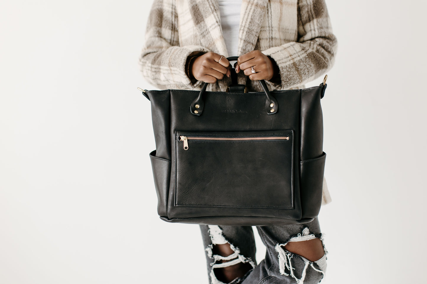 Carry the Legacy Voyager bag by the handles.