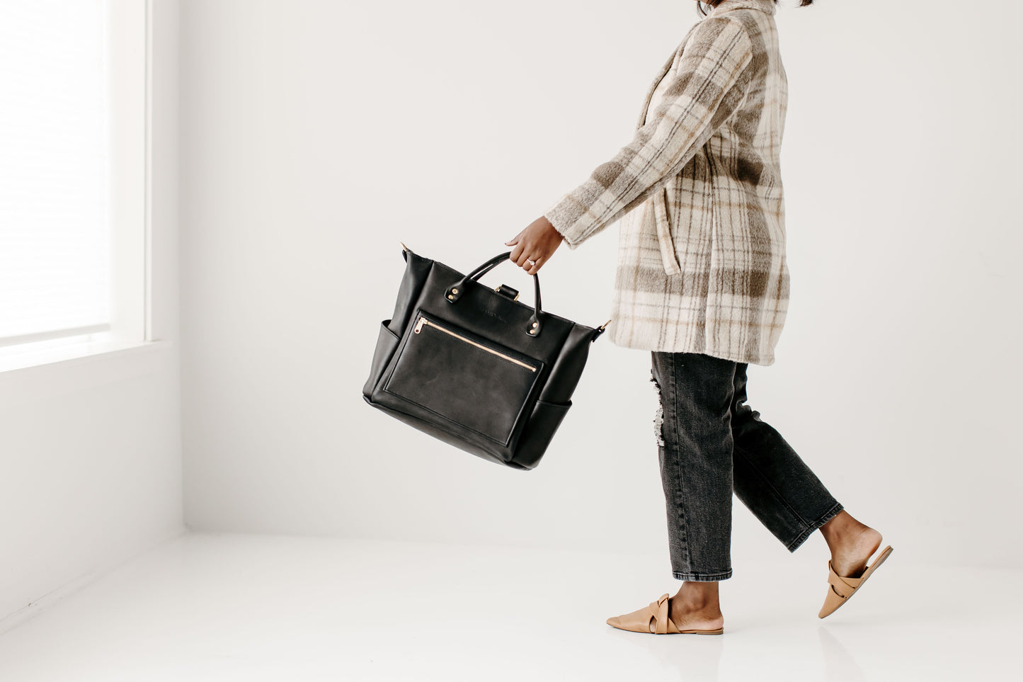 Carry the Legacy Backpack Tote by the handles with the straps removed.