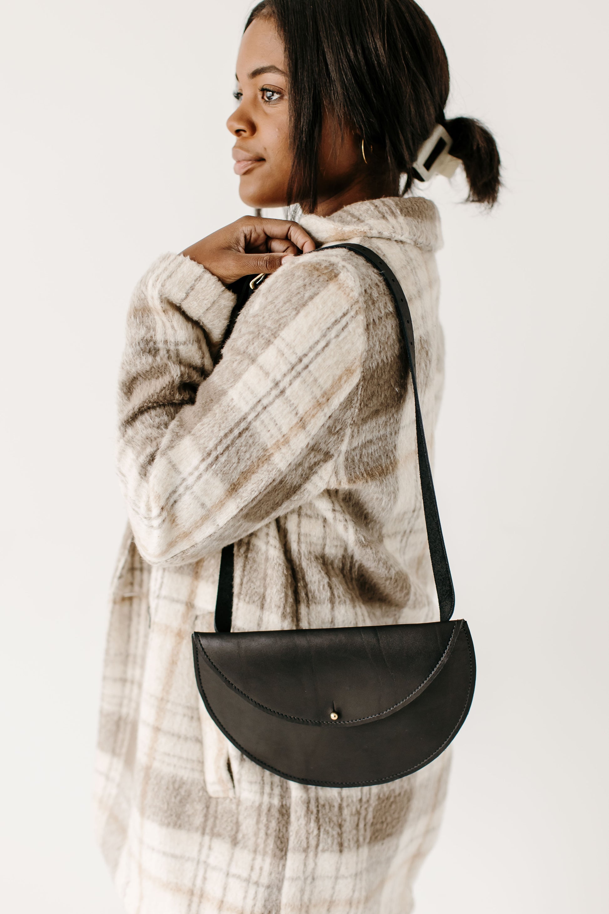The Urban Southern handcrafted leather Half Moon Belt Bag in black. The Half Moon Belt Bag can also be carried like a traditional bag, hanging from the shoulder. 