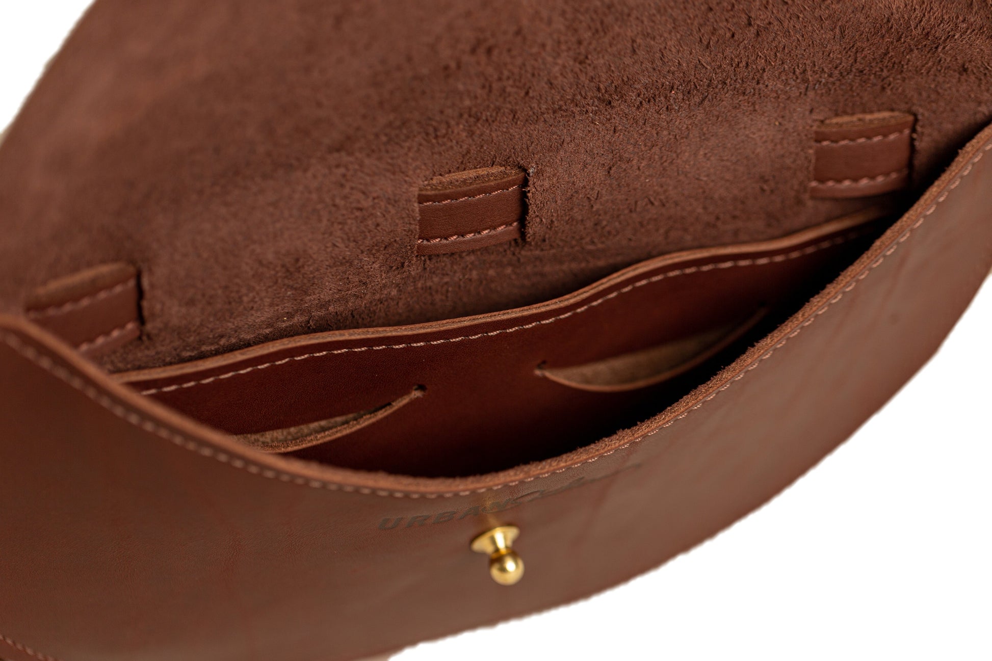 Inside of Half Moon Belt Bag has cash pocket, two card slots, one large interior pocket, and the Urban Southern engraved logo above the brass post closure.